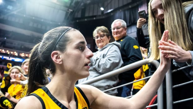 Iowa guard Caitlin Clark greets fans after defeating Cleveland State during the Hawkeye Showcase at Wells Fargo Arena in Des Moines, Iowa on Dec. 16, 2023.