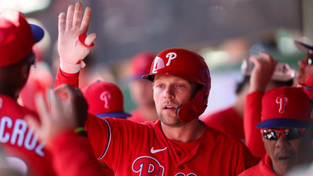 Philadelphia Phillies first baseman Rhys Hoskins (17) is congratulated after hitting a home run against the Boston Red Sox during a spring training game.