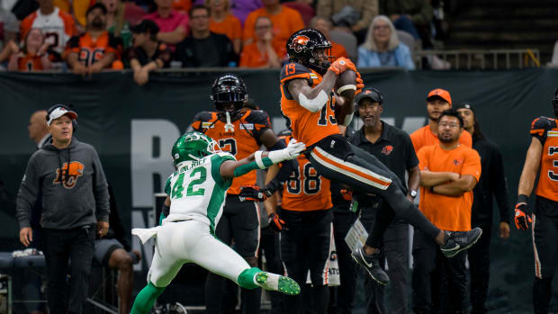 Aug 26, 2022; Vancouver, British Columbia, CAN; BC Lions wide receiver Dominique Rhymes (19) makes catch in front of Saskatchewan Roughriders linebacker Derrick Moncrief (42) in the second half at BC Place. Mandatory Credit: Bob Frid-USA TODAY Sports  
