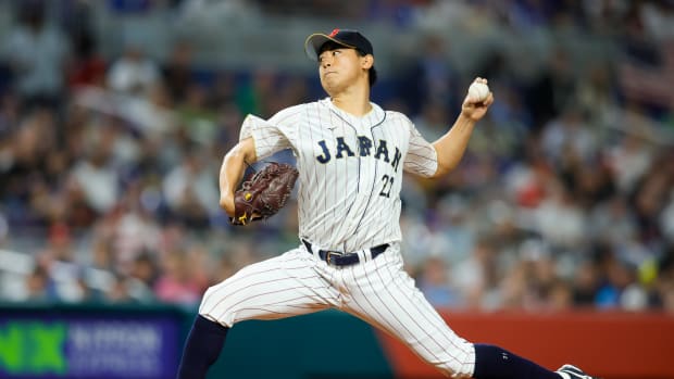 Mar 21, 2023; Miami, Florida, USA; Japan starting pitcher Shota Imanaga (21) delivers a pitch during the first inning against USA at LoanDepot Park. Mandatory Credit: Sam Navarro-USA TODAY Sports