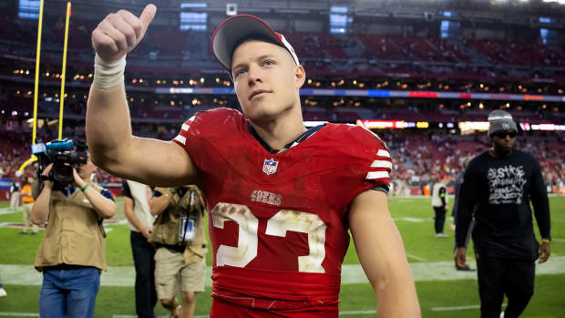 Christian McCaffrey walks off the field after the 49ers’ win over the Cardinals.