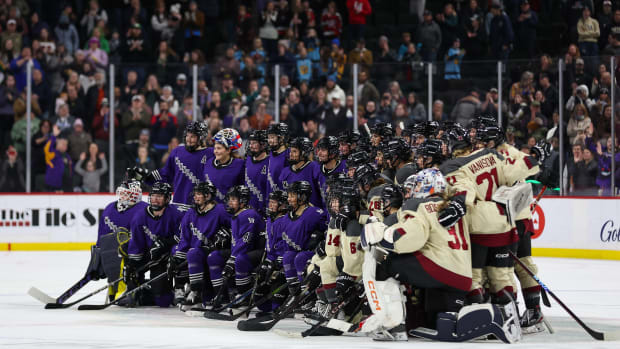 Minnesota and Montreal players pose for a photograph after the former's 3-0 win on Jan. 6, 2024.
