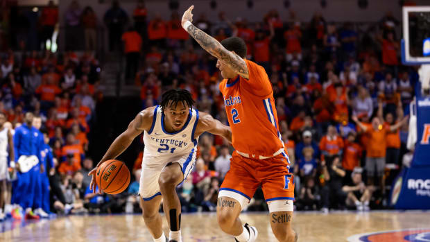 Jan 6, 2024; Gainesville, Florida, USA; Kentucky Wildcats guard D.J. Wagner (21) dribbles the ball at Florida Gators guard Riley Kugel (2) during the first half at Exactech Arena at the Stephen C. O'Connell Center. Mandatory Credit: Matt Pendleton-USA TODAY Sports