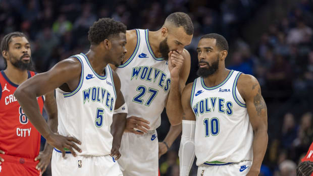 Jan 3, 2024; Minneapolis, Minnesota, USA; Minnesota Timberwolves guard Anthony Edwards (5), center Rudy Gobert (27) and guard Mike Conley (10) talk during a free throw against the New Orleans Pelicans in the first half at Target Center.