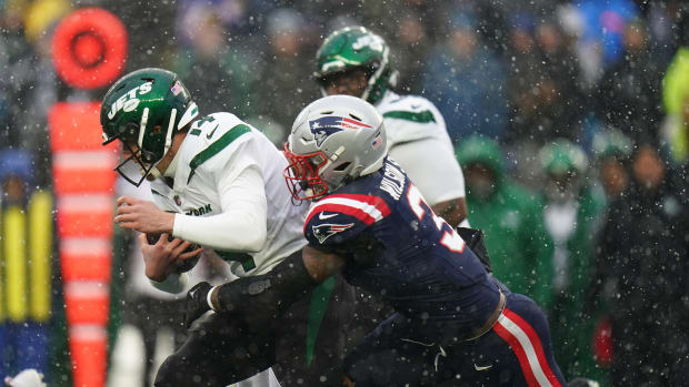 New York Jets quarterback Trevor Siemian (14) is sacked by New England Patriots linebacker Mack Wilson Sr. (3) in the first quarter at Gillette Stadium.