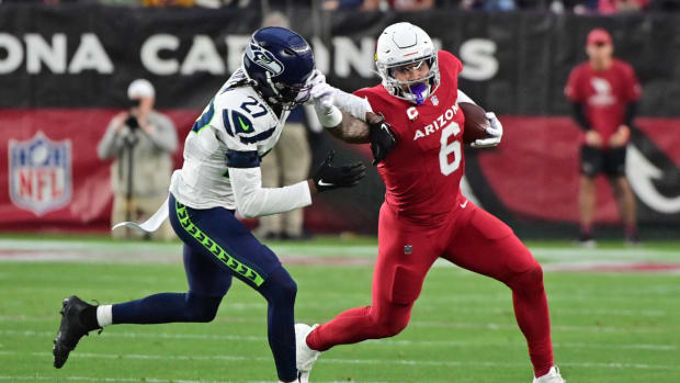 Arizona Cardinals running back James Conner (6) stiff arms Seattle Seahawks cornerback Riq Woolen (27) in the first half at State Farm Stadium.