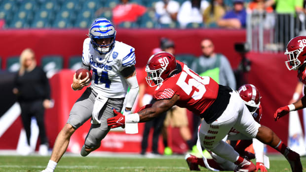 Oct 2, 2021; Philadelphia, Pennsylvania, USA; Memphis Tigers quarterback Seth Henigan (14) carries the ball past Temple Owls defensive tackle Darian Varner (50) in the second half at Lincoln Financial Field. Mandatory Credit: Kyle Ross-USA TODAY Sports