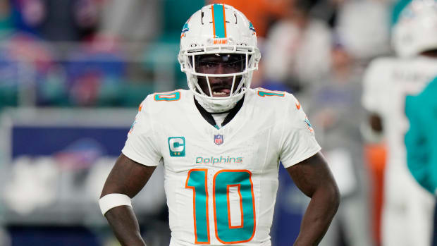Dolphins wide receiver Tyreek Hill stands with his hands on his hips