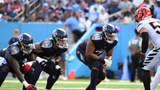 Tennessee Titans offensive tackle Andre Dillard (71) offensive tackle Dillon Radunz (75) and guard Aaron Brewer (55) wait for the snap during the second half against the Cincinnati Bengals at Nissan Stadium.