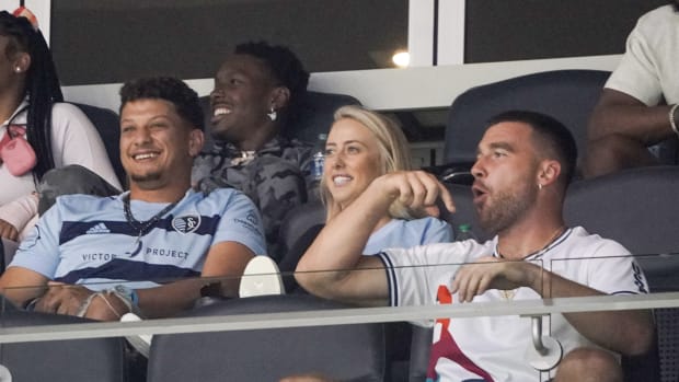 May 10, 2022; Kansas City, Kansas, USA; Kansas City Chiefs quarterback Patrick Mahomes, wife Britney, and tight end Travis Kelce watch play during the second half of the match between Sporting Kansas City and FC Dallas at Children's Mercy Park. Mandatory Credit: Denny Medley-USA TODAY Sports  