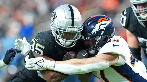 Las Vegas Raiders running back Zamir White (35) is tackled by Denver Broncos linebacker Josey Jewell (47) during the third quarter at Allegiant Stadium.