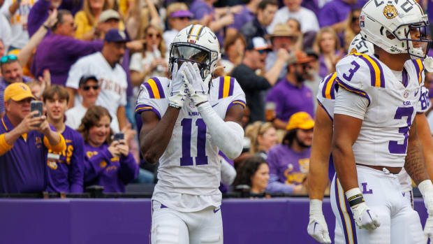 Nov 25, 2023; Baton Rouge, Louisiana, USA; LSU Tigers wide receiver Brian Thomas Jr. (11) catches a touchdown against Texas A&M Aggies defensive back Sam McCall (16) during the second half at Tiger Stadium. Mandatory Credit: Stephen Lew-USA TODAY Sports  