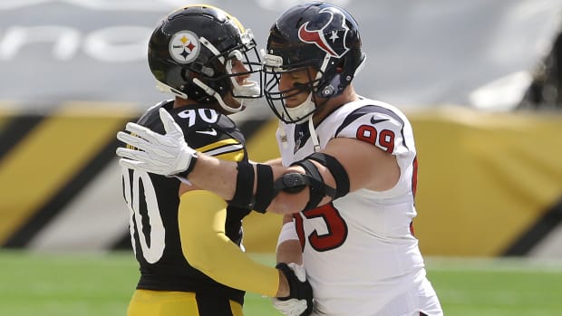 Brothers Pittsburgh Steelers outside linebacker T.J. Watt (90) and Houston Texans defensive end J.J. Watt (99) embrace after the coin toss at Heinz Field.