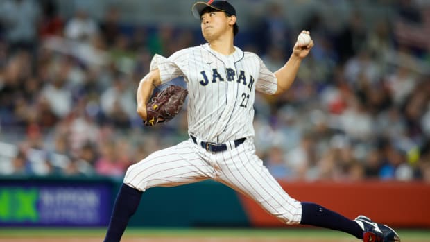 Mar 21, 2023; Miami, Florida, USA; Japan starting pitcher Shota Imanaga (21) delivers a pitch during the first inning against USA at LoanDepot Park. Mandatory Credit: Sam Navarro-USA TODAY Sports  