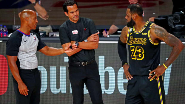 Oct 9, 2020; Lake Buena Vista, Florida, USA; Miami Heat head coach Erik Spoelstra talks with Los Angeles Lakers forward LeBron James (23) during the second quarter in game five of the 2020 NBA Finals at AdventHealth Arena. Mandatory Credit: Kim Klement-USA TODAY Sports  