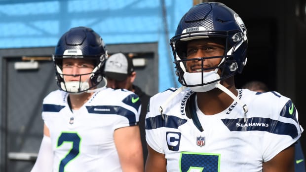 Seattle Seahawks quarterback Geno Smith (7) and quarterback Drew Lock (2) take the field before the game against the Tennessee Titans at Nissan Stadium.