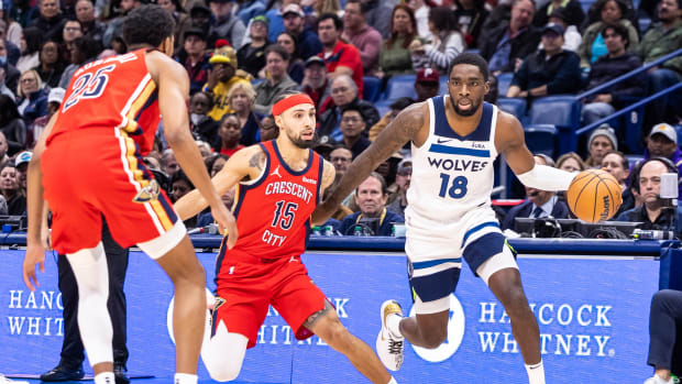Dec 11, 2023; New Orleans, Louisiana, USA; Minnesota Timberwolves guard Shake Milton (18) dribbles against New Orleans Pelicans guard Jose Alvarado (15) during the first half at the Smoothie King Center.