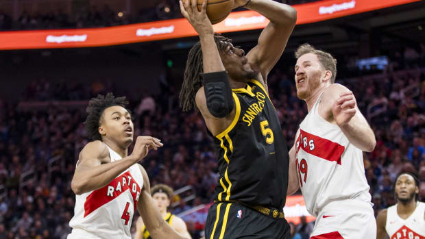 Jan 7, 2024; San Francisco, California, USA; Toronto Raptors guard Scottie Barnes (4) and center Jakob Poeltl (19) defends against Golden State Warriors center Kevon Looney (5) during the first half at Chase Center.
