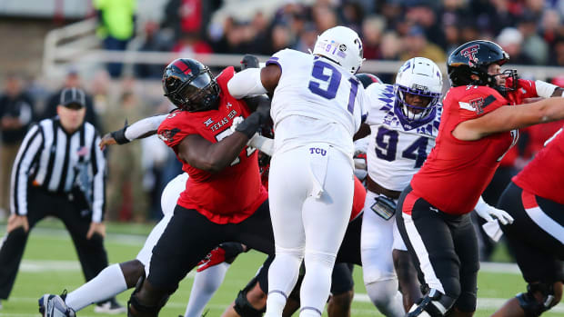 Texas Tech Red Raiders offensive guard Jacoby Jackson (75) blocks Texas Christian Horned Frogs defensive tackle Tymon Mitchell (91) in the first half at Jones AT&T Stadium and Cody Campbell Field.