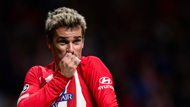 Antoine Griezmann pictured kissing the Atletico Madrid crest on his jersey after scoring a goal in a 2-0 win over Lazio in December 2023