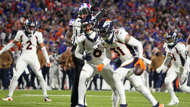 Nov 13, 2023; Orchard Park, New York, USA; Denver Broncos safety Justin Simmons (31) reacts after intercepting a pass with safety P.J. Locke (6) against the Buffalo Bills during the first half at Highmark Stadium. Mandatory Credit: Gregory Fisher-USA TODAY Sports  