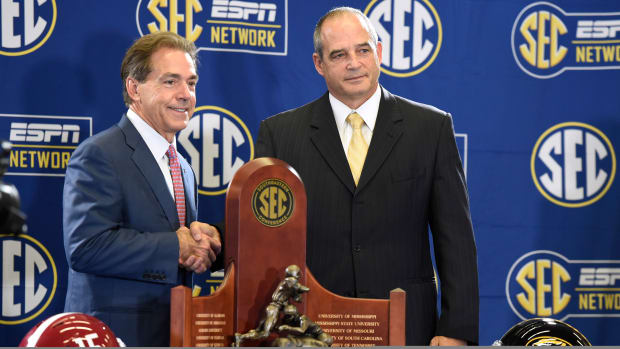 Dec 5, 2014; Atlanta, GA, USA; Alabama Crimson Tide head coach Nick Saban and Missouri Tigers head coach Gary Pinkel shake hands as they pose for photos with the Southeastern Conference trophy during a press conference at the Georgia Dome. Missouri plays the Alabama Crimson Tide in the SEC Championship Saturday. Mandatory Credit: John David Mercer-USA TODAY Sports