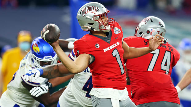 UNLV quarterback Jayden Maiava (1) throws a pass during the second half against Kansas in the Guaranteed Rate Bowl at Chase Field.