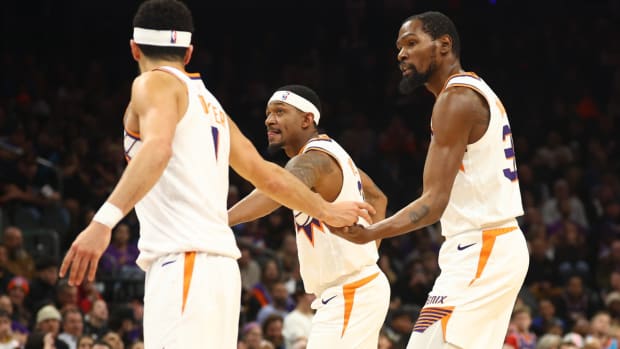 Phoenix Suns guard Devin Booker with guard Bradley Beal (3) and forward Kevin Durant (35) against the Brooklyn Nets at Footprint Center.