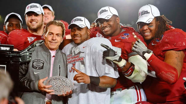 Nick Saban stands with the national championship trophy in 2009