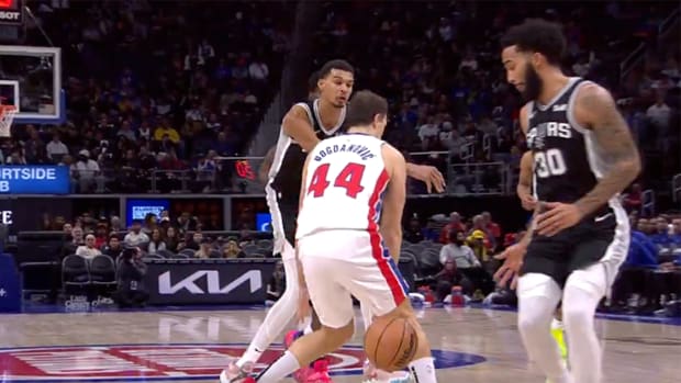 San Antonio Spurs rookie Victor Wembanyama passes through the legs of Detroit Pistons’ Bojan Bogdanovic.