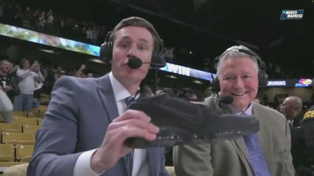 Commentators Mark Neely and Mike O’Donnell react to a shoe being thrown after UCF beating Kansas.