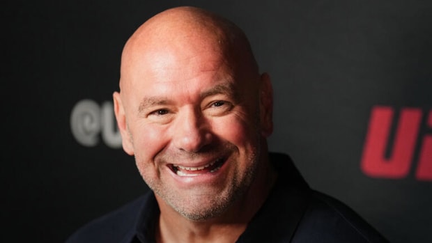 UFC CEO Dana White laughing during a media scrum.