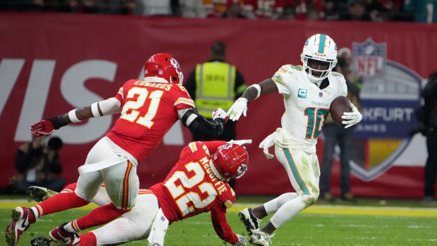 Nov 5, 2023; Frankfurt, Germany; Miami Dolphins wide receiver Tyreek Hill (10) carries the ball against Kansas City Chiefs safety Mike Edwards (21) and cornerback Trent McDuffie (22) in the second half during an NFL International Series game at Deutsche Bank Park. Mandatory Credit: Kirby Lee-USA TODAY Sports  