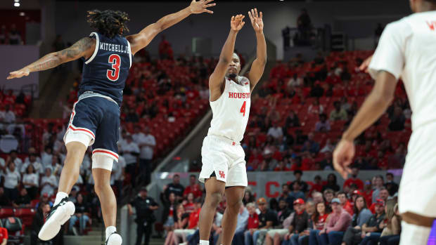 Dec 9, 2023; Houston, Texas, USA; Houston Cougars guard LJ Cryer (4) shoots the ball as Jackson State Tigers guard Jayme Mitchell (3) defends during the second half at Fertitta Center. Mandatory Credit: Troy Taormina-USA TODAY Sports