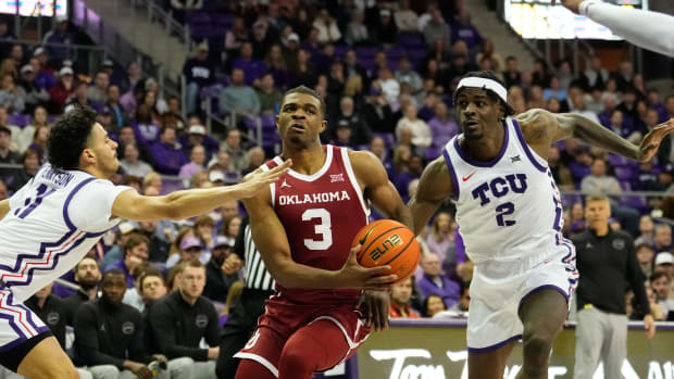 Jan 10, 2024; Fort Worth, Texas, USA; Oklahoma Sooners guard Otega Oweh (3) drives to the basket between TCU Horned Frogs forward Emanuel Miller (2) and guard Trevian Tennyson (11) during the second half at Ed and Rae Schollmaier Arena. 