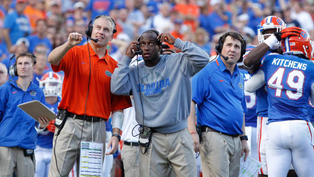Nov 23, 2013; Gainesville, FL, USA; Florida Gators defensive coordinator D.J. Durkin, defensive backs coach Travaris Robinson and head coach Will Muschamp during the second quarter against the Georgia Southern Eagles at Ben Hill Griffin Stadium. (Kim Klement / USA TODAY Sports).