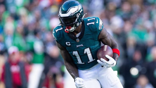 Philadelphia Eagles wide receiver A.J. Brown runs with a ball in a game.
