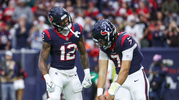 Houston Texans wide receiver Nico Collins (12) celebrates with quarterback C.J. Stroud (7) after a touchdown in a 2024 AFC wild card game against the Cleveland Browns at NRG Stadium.