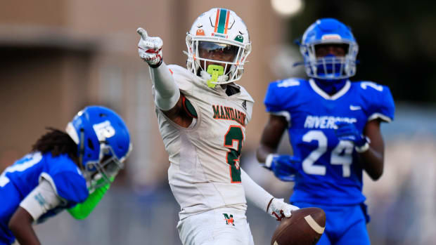 Mandarin's Jaime Ffrench Jr. (2) reacts to a first down pick up against Riverside's King Taylor (12) and Ronald \"RJ\" Bertrand (24) during the second quarter of a regular season high school football matchup Friday, Sept. 8, 2023 at Riverside High School in Jacksonville, Fla. The Mandarin Mustangs defeated the Riverside Generals 50-20.