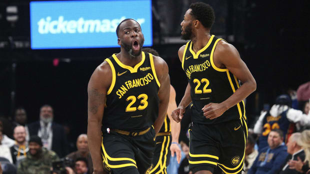 Golden State Warriors forwards Draymond Green (23) and Andrew Wiggins (22).