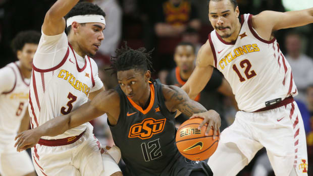 Iowa State Cyclones guard Tamin Lipsey (3) and Iowa State Cyclones forward Robert Jones (12) defend as Oklahoma State Cowboys guard Javon Small (12) drives with the ball during the second half in the Big-12 conference showdown of an NCAA college basketball at Hilton Coliseum on Saturday, Jan. 13, 2024, in Ames, Iowa.