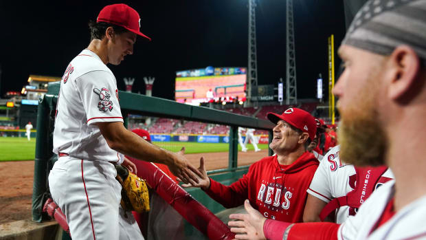 Cincinnati Reds pitcher Connor Phillips (34) shakes hands with Cincinnati Reds manager David Bell (25) in the middle of the seventh inning of a baseball game against the Minnesota Twins, Monday, Sept. 18, 2023, at Great American Ball Park in Cincinnati.  