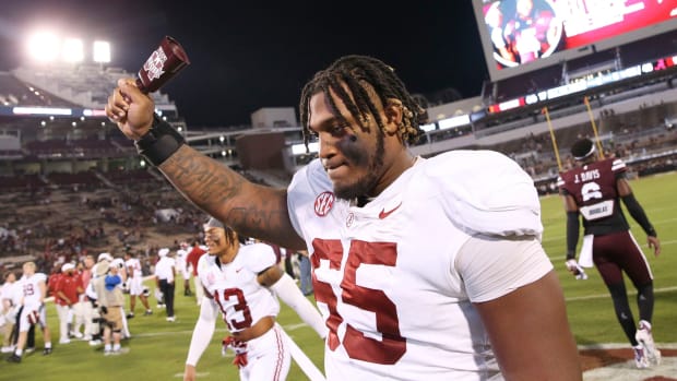 Sep 30, 2023; Starkville, Mississippi, USA; Alabama Crimson Tide offensive lineman JC Latham (65) celebrates with a cow bell in Davis Wade Stadium at Mississippi State University. Alabama defeated Mississippi State 40-17. Mandatory Credit: Gary Cosby Jr.-Tuscaloosa News  