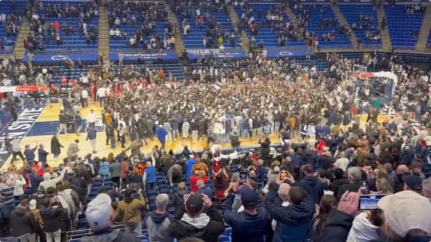 Penn State fans storm the court after the Nittany Lions' 87-83 win over No. 11 Wisconsin in a Big Ten men's basketball game at the Bryce Jordan Center.