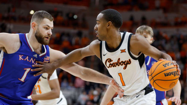 Oklahoma State Cowboys guard Bryce Thompson (1) tries to get past Kansas Jayhawks center Hunter Dickinson (1) during a college basketball game between the Oklahoma State University Cowboys (OSU) and the Kansas Jayhawks at Gallagher-Iba Arena in Stillwater, Okla., Tuesday, Jan. 16, 2024.