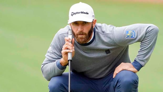 Dustin Johnson lines up a putt at the 2022 Masters Tournament.