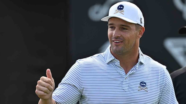 Bryson DeChambeau interacts with fans while warming up during the first round of the 2023 LIV Golf Chicago golf tournament at Rich Harvest Farms.