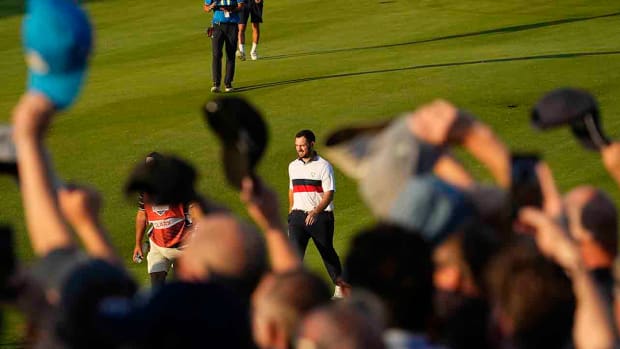 Spectators wave their caps towards Team USA golfer Patrick Cantlay on the 16th hole during Day 2 fourballs at the 2023 Ryder Cup.