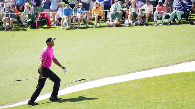 Tiger Woods climbs the hill to the 18th green in the first round of the 2022 Masters.
