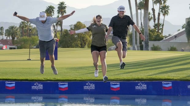 Jennifer Kupcho (center) jumps in to Poppies Pond with her husband Jay Monahan (right) and her caddie David Eller after winning the Chevron Championship.